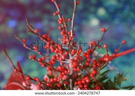 Decoration with fresh red and pink flowers, red balls, decorated flower with green plants, Christmas bouquet for table decoration christmas flowers in red color in the bouquet and leaves