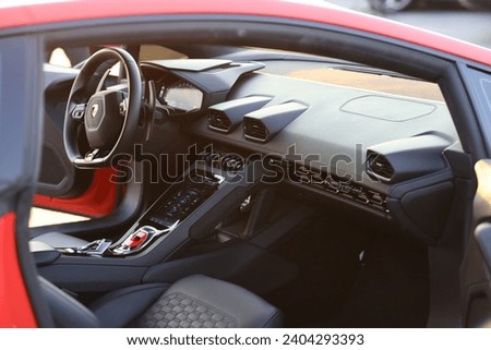 Capturing the epitome of automotive luxury and performance, this image showcases the sleek and stylish Lamborghini steering wheel Royalty-Free Stock Photo #2404293393