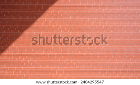 Sunlight and shadow on orange brick pattern surface of prefabricated smart board wall background