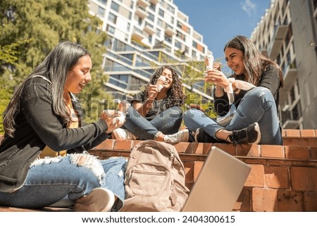 Three beautiful Latin girls share a sunny day and enjoy the moment. Royalty-Free Stock Photo #2404300615