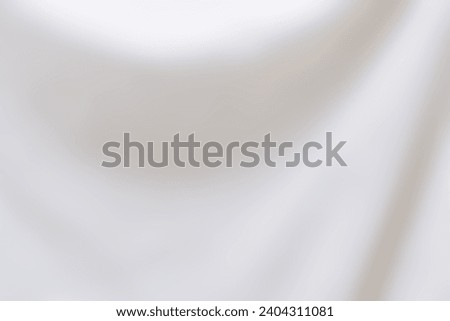 Abstract white background with a smooth curve. Blurred bright background from white fabric backdrop. Luxury and elegant white background of blurry fabric texture. Minimalism beige color concept.
