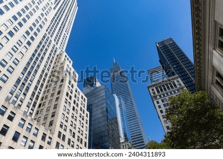 Beautiful Buildings and Skyscrapers with a Blue Sky in Midtown Manhattan of New York City Royalty-Free Stock Photo #2404311893
