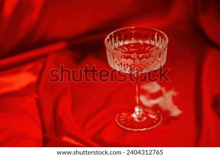 Extravagant bedroom luxury interior with love glamur decoration at Valentine day in studio. Balloons by heart shaped and at illuminated mirror romantic cozy atmosphere at vivid red background.  Royalty-Free Stock Photo #2404312765