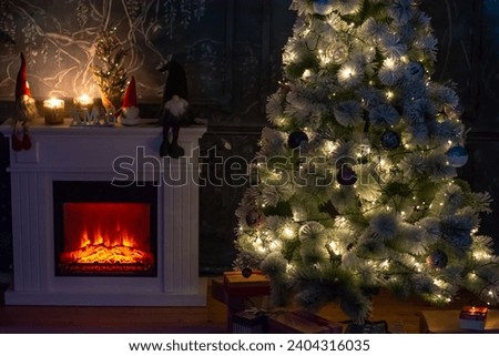 Christmas Tree with gifts and a fireplace with lights