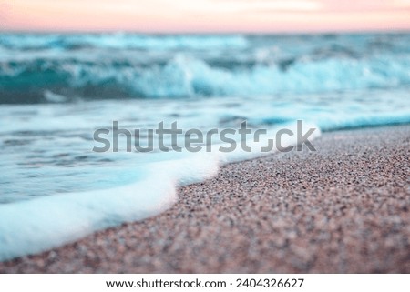 Close up sea water with foam and waves photo. Sand beach surface with selective focus. Mediterranean sea, nautical background. High quality picture for wallpaper, travel blog