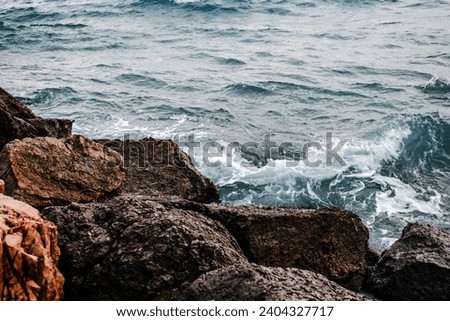 Winter sea with stones on the beach concept photo. Underwater rock. Mediterranean sea. The view from the top, nautical background. High quality picture for wallpaper