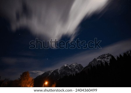Starry sky above Lienz, the Dolomites in the background, cloud puller and the moon