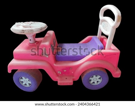 A toy car for children, four wheels, pink and a little dirty, made of plastic.