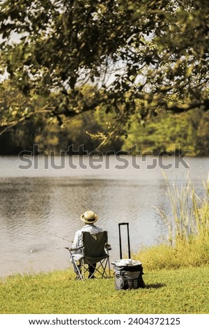 very calm elderly person sitting in the lake