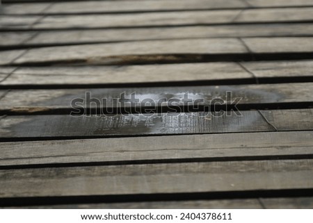 This is a photo of the bridge wood which is brown and slightly wet