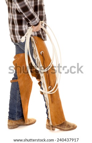 a cowboy's legs holding on to a rope.