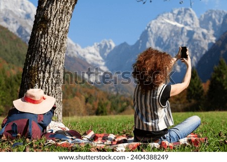 Woman Hiker Taking a Rest Under a Tree in Mountains Countryside