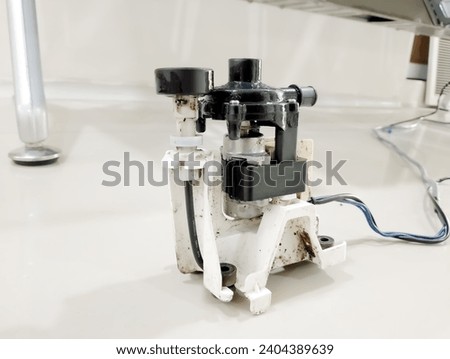 Cassette air conditioner motor drain pump.Centrifugal condensate drain pump specially designed for ceiling air conditioners Royalty-Free Stock Photo #2404389639