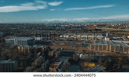 Top view from a drone of the final station of the San Donato M3 metro and Bus station. Italy, San Donato Milanese. ATM - Azienda Trasporti Milanes.  Royalty-Free Stock Photo #2404444075