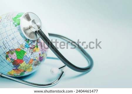 globe care with stethoscope blue background