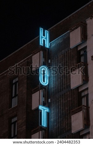 LED sign for a hotel, with the words "hot" in blue.