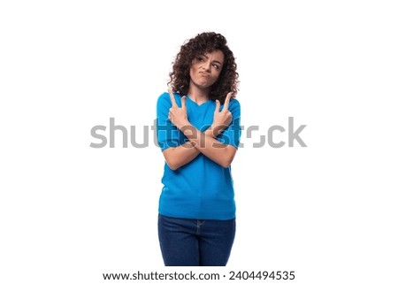 young woman with curly natural hair styling crossed her arms in front of her
