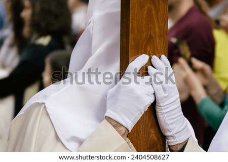 A penitent holding the cross, Valladolid Holy week, Spain Royalty-Free Stock Photo #2404508627