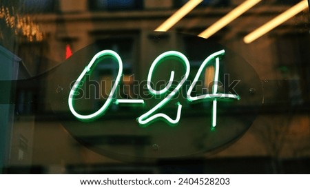 0-24 neon sign in front of a shop window in Zagreb, Croatia.