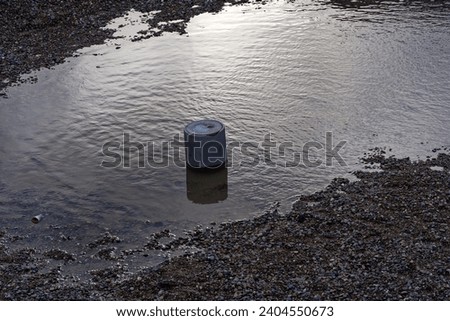 Aerial view of puddle surrounded by gravel with Glatt River in the background at Swiss City of Zürich on a rainy winter day. Photo taken December 24th, 2023, Zurich, Switzerland,