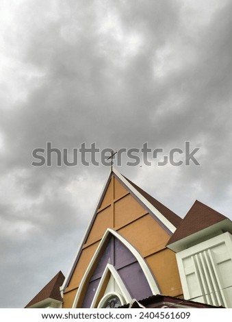 This picture shows a place of worship, namely a church with a view of the cloudy sky