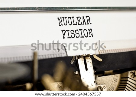 Nuclear fission symbol. Concept words Nuclear fission typed on beautiful old retro typewriter. Beautiful white paper background. Business science nuclear fission concept. Copy space. Royalty-Free Stock Photo #2404567557