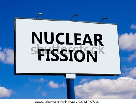 Nuclear fission symbol. Concept words Nuclear fission on beautiful big white billboard. Beautiful blue sky cloud background. Business science nuclear fission concept. Copy space. Royalty-Free Stock Photo #2404567641