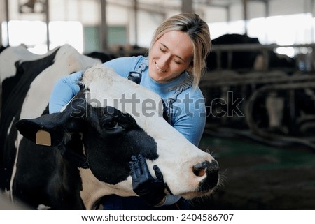 Concept agriculture cattle livestock farming industry. Farmer Happy young woman hugging cow, concept veterinary health care. Royalty-Free Stock Photo #2404586707