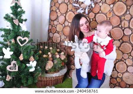 Mother And Son Celebrate Holiday, Opening Present Gift Box. Family sitting together in Christmas interior. Happy family having fun with Christmas presents. Christmas Family Portrait, 