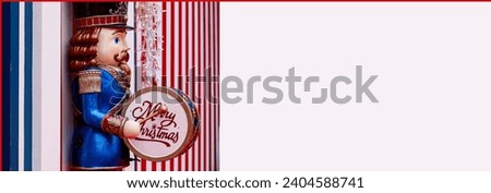 Merry Christmas greeting card, drummer soldier with dominant blue and red colors, banner format.
