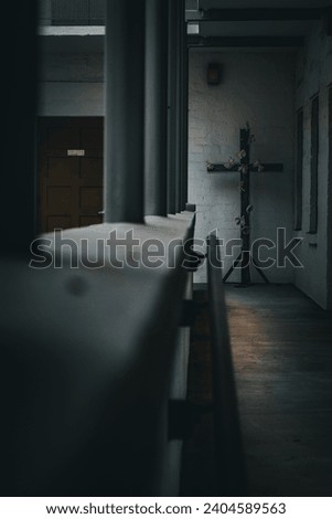 Dark picture with a cross at the end