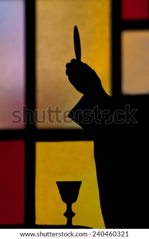 priest lifting host during the Eucharist sacrament in a Catholic church