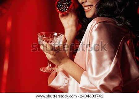 Extravagant glamour background with coupe glass of sparkly wine for love party at muffled light. Beautiful romantic burlesque place for st valentines holiday in red silk glossy sheets Royalty-Free Stock Photo #2404603741