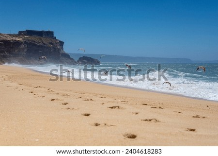 North Beach famous for giant waves in Nazare town on so called Silver Coast, Oeste region of Portugal, view with fort of Saint Michael the Archangel