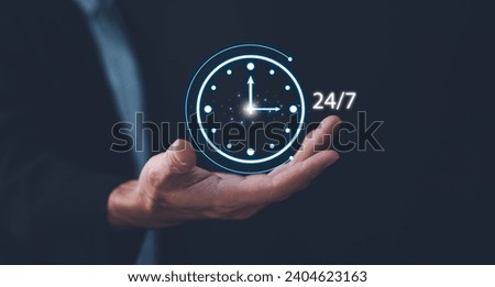 Nonstop service concept. Businessman show virtual 24-7 with clock for worldwide nonstop and full-time available contact of customer service concept. Full-time available contact of service concept. Royalty-Free Stock Photo #2404623163