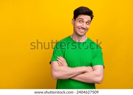 Photo of attractive guy brunet hair crossed arms looking curious empty space interesting sportive event isolated on yellow color background Royalty-Free Stock Photo #2404627509