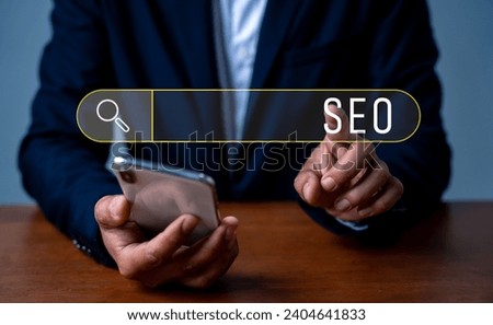 Search engine optimization marketing ranking. Working on smartphone with the icon of online search engine, abbreviation SEO and SEO symbol. Digital marketing strategy of promoting traffic to website.