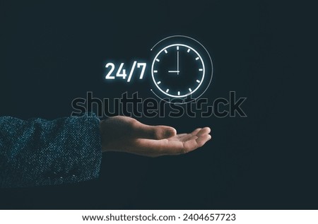 Customer service. nonstop service concept. businessman hand holding virtual 24-7 with clock on hand for worldwide nonstop and full-time available contact of service concept.  Royalty-Free Stock Photo #2404657723