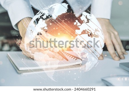 Multi exposure of abstract graphic world map and hand writing in notepad on background with laptop, connection and communication concept