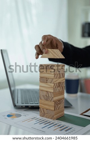 Business investment and economic growth Businessmen are making financial plans to achieve their financial goals and contribute to the company's profits. Close-up with wooden blocks placed in front.