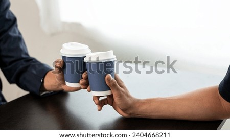 Group of businessmen drinking coffee for success in work or chatting and clinking coffee cups together. Close-up pictures