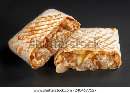 French tacos with grilled chicken. Cut French Tacos close up on black background. Delicious french taco sandwich fastfood nice good amazing food