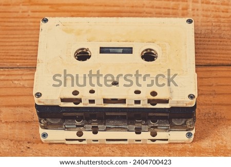 Toned Photo of Old Audio Cassettes on a Wooden Planks Background closeup