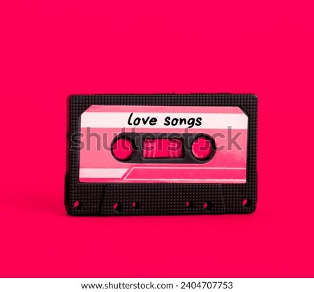 Retro vintage tape cassette with love songs on pink background. Minimal art poster.