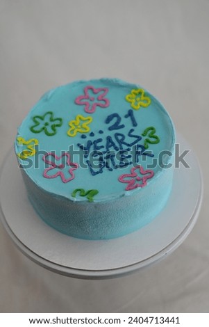 21 years old happy birthday pastel cyan turquoise frosted icing cake on white background studio shot Royalty-Free Stock Photo #2404713441