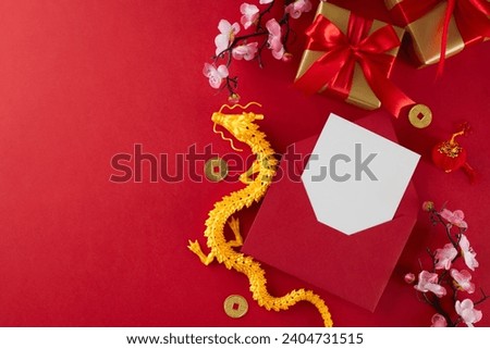 Gift ideas for Chinese New Year celebrations. Top view shot of festive gift boxes, red envelope with card, decor elements, gold dragon on red background with advert placement