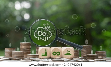 The concept of carbon credit to limit global warming from climate change. Wooden cubes with icon in stack of silver coins. Tax credits and green taxation.