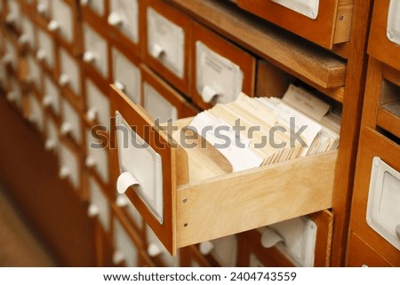 Closeup view of library card catalog drawers Royalty-Free Stock Photo #2404743559