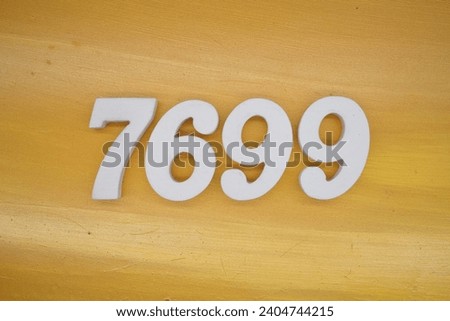 The golden yellow painted wood panel for the background, number 7699, is made from white painted wood.