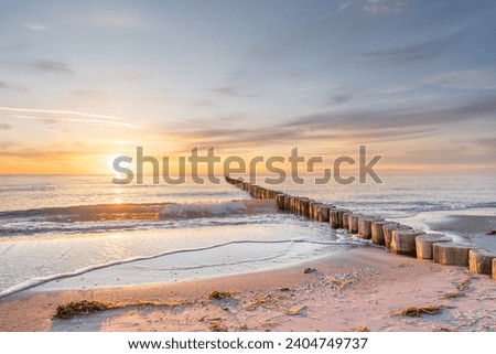 Sunset on the Baltic Sea beach Royalty-Free Stock Photo #2404749737